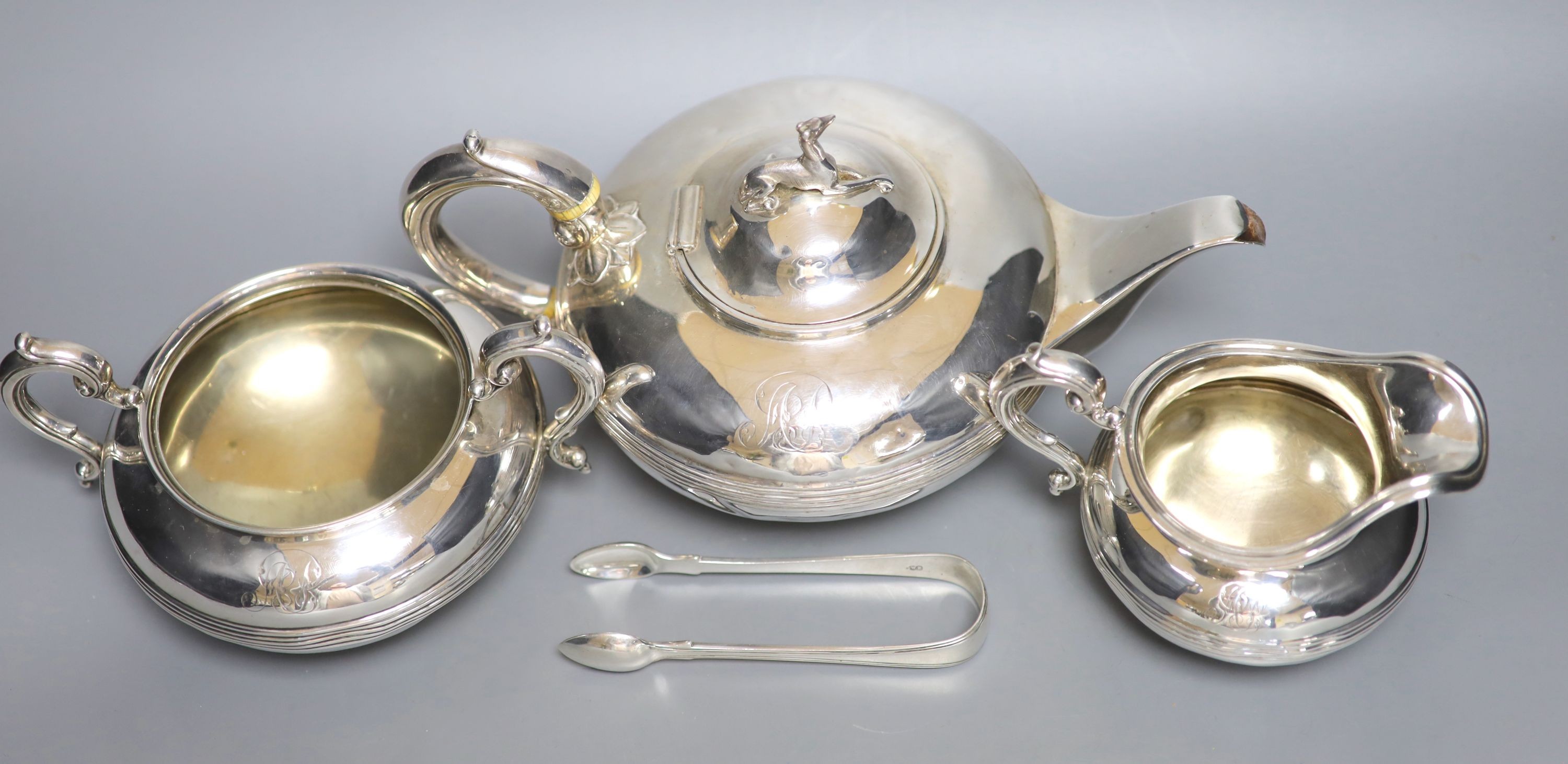A Victorian silver three piece silver tea set, William Smily, London, 1856 and a pair of earlier silver sugar tongs, gross weight 40 oz.
